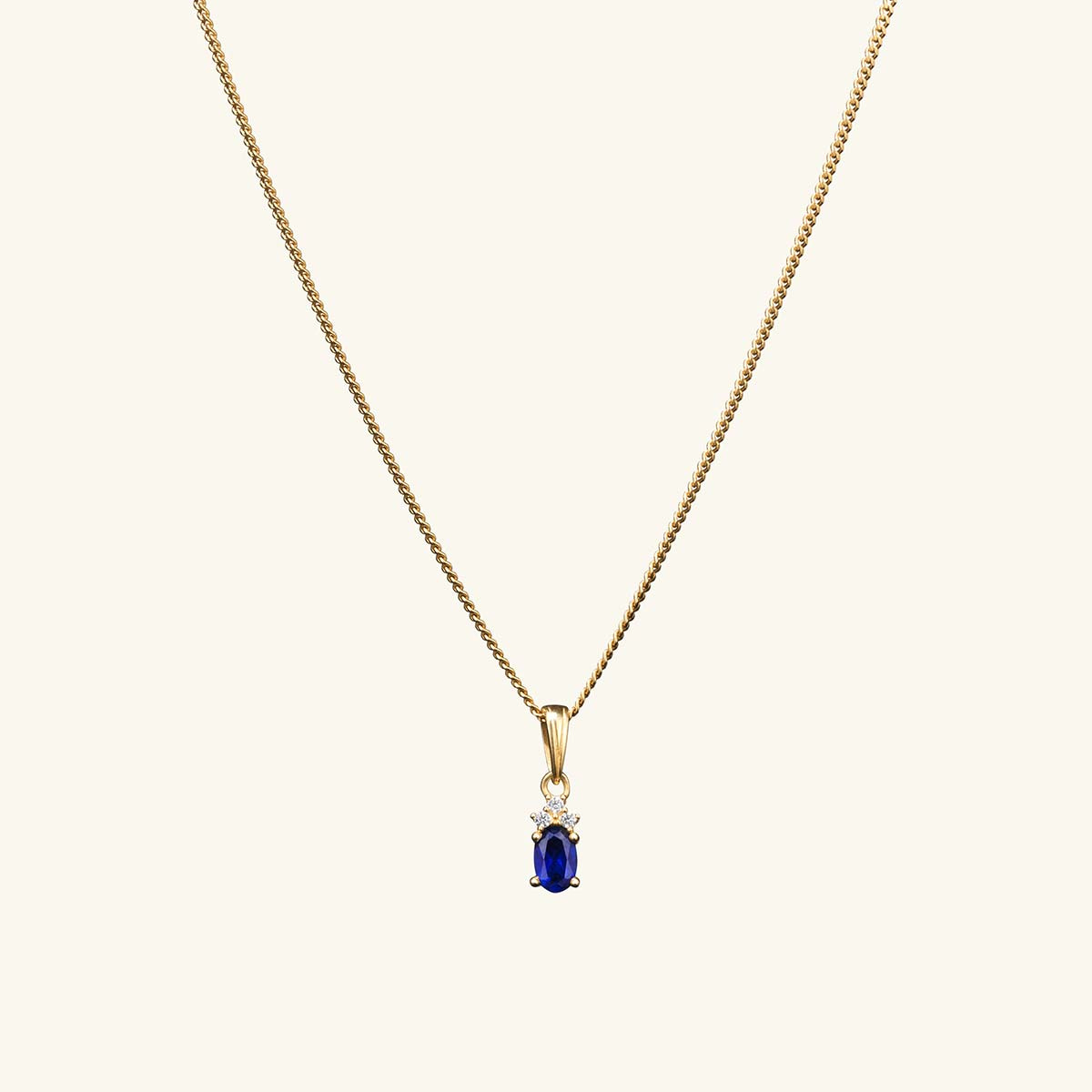 gold chain with blue pendant